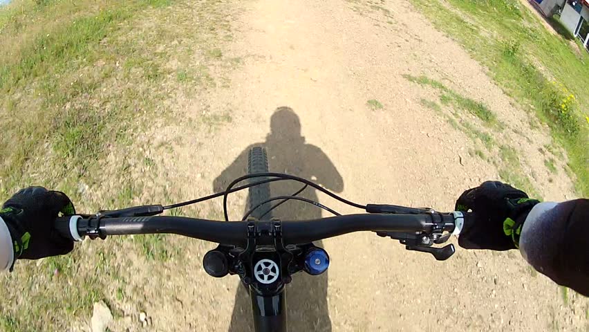 Downhill front view. Ride a bike over terrain pov. 