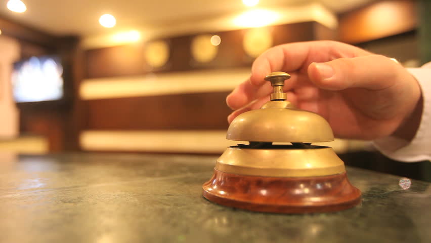 call on a old hotel bell on a wood stand
