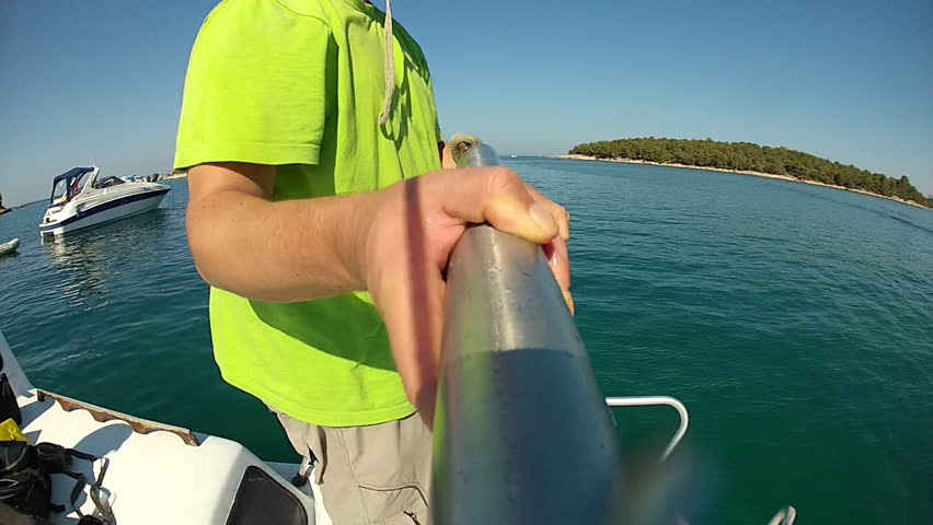 Anchor fall. Man throwing an anchor to the sea. pov. 