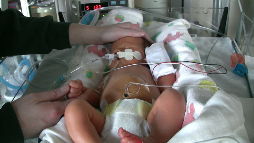Neonatal unit with premature baby getting touched by mom.  HD 1080i