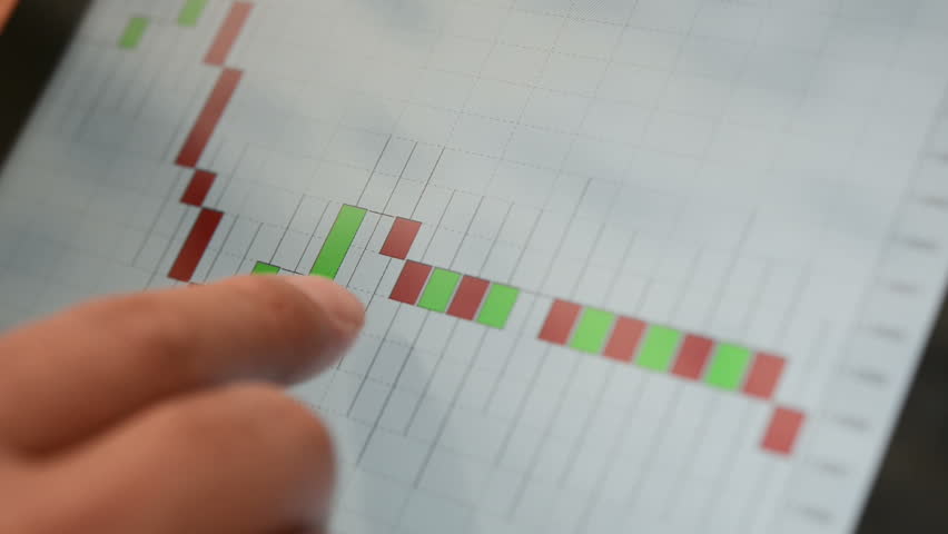 touching screen of tablet pc with market graph