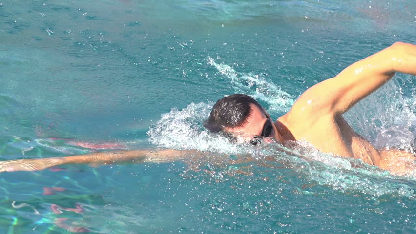 crawl swimmer in slow motion in outdoor swimming pool