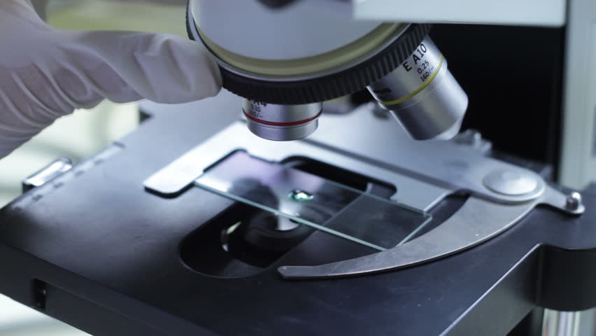 hd video of female scientist use microscope in lab close up/scientist microscope/scientist use microscope in lab close up