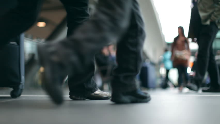 Passengers with luggage at a modern Station in 1080p HD with bokeh