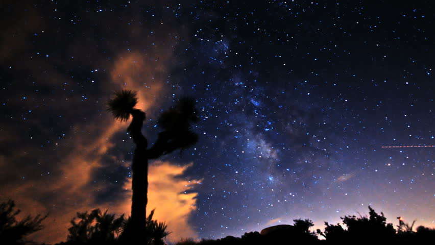 Gorgeous long-exposure time lapse shot of the Milky Way and Stars Galaxy. Passing over Joshua Tree Desert. 