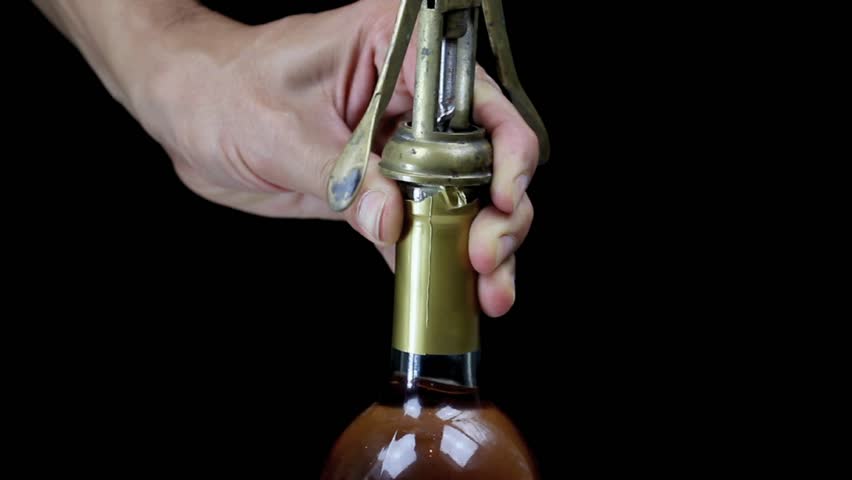 using a corkscrew over black background 