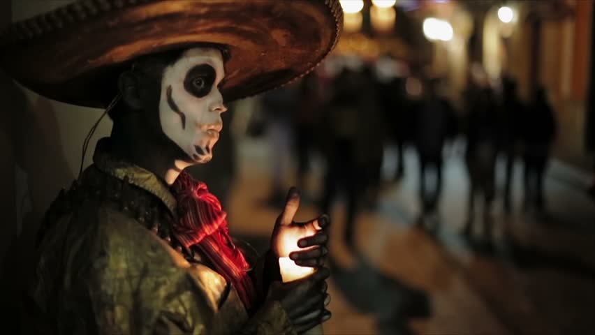 Artist with face painted like skull in Mexican Holiday Day of Dead
