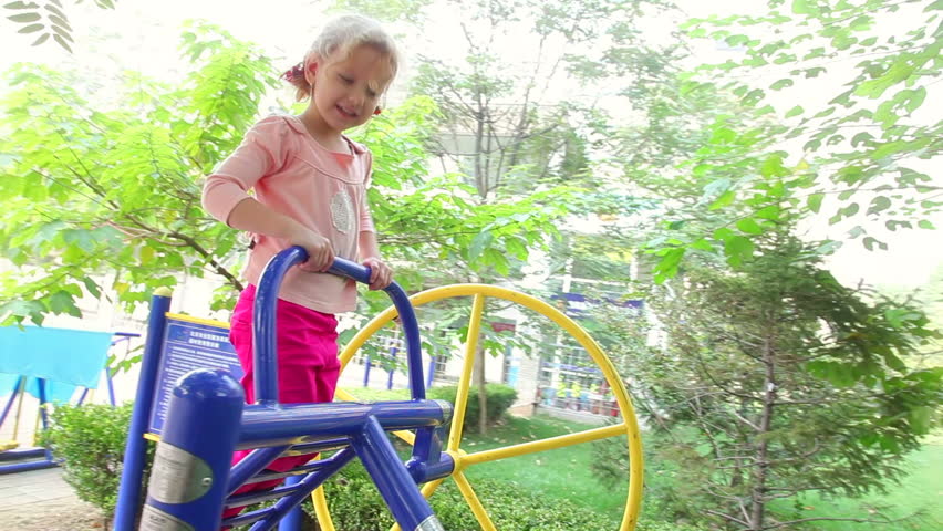 Happy little girl climbing in playground