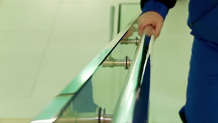 Worker is holding onto a railing when climbing stairs