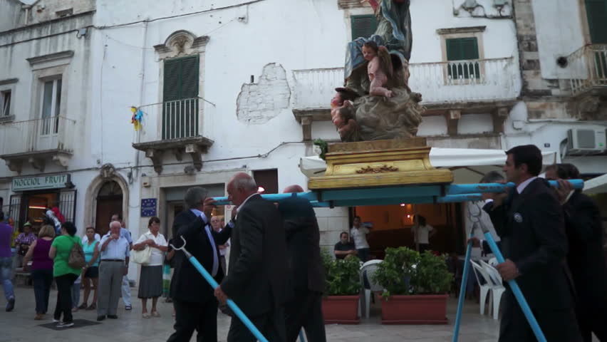 MARTINA FRANCA, ITALY - AUGUST 15: The marching band escorts the traditional Procession of Our Lady of the Assumption, followed by the Christian population parading through the city streets on August 15, 2012 in Martina Franca, Italy.