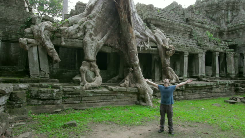 a man raising arms in mysterious preah khan temple, Angkor