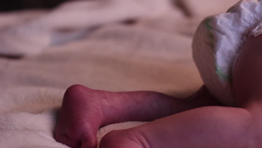 Baby sleeping crying in red and diaper
