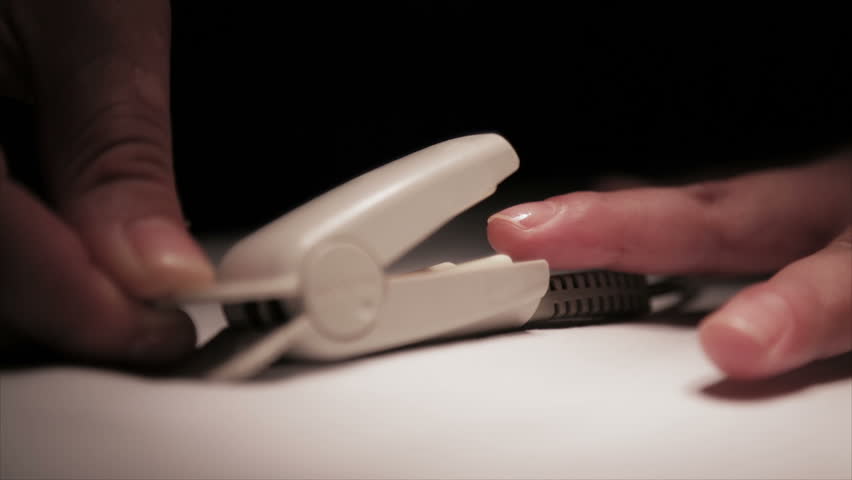Pressing clip of pulse oximeter on finger measuring Vital sign 