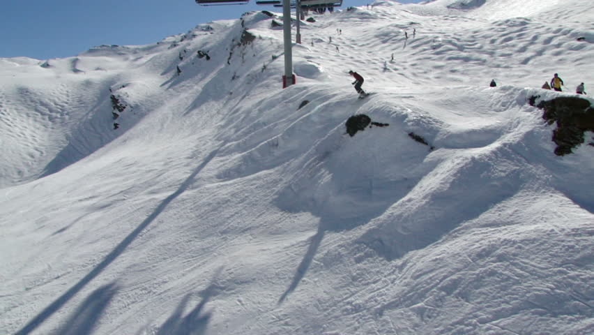 Watching open slope mogul skiers from a moving chairlift 		in Avoriaz, in the Portes du Soleil, France
