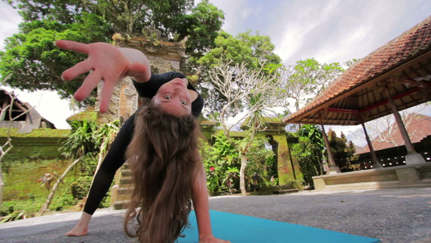 Caucasian woman meditating yoga in Balinese temple