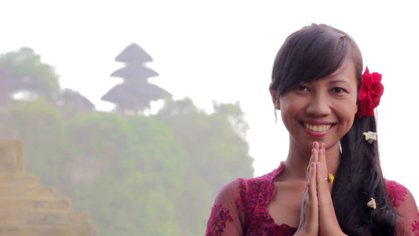 Balinese girl saluting with both hands