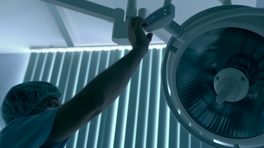 surgeon turns on light in hospital room 
