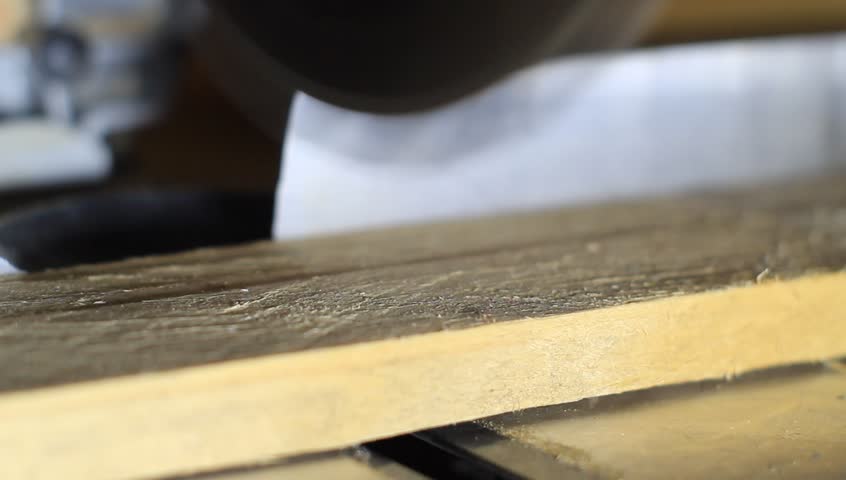 a buzz saw or circular saw is used to cut some wooden board