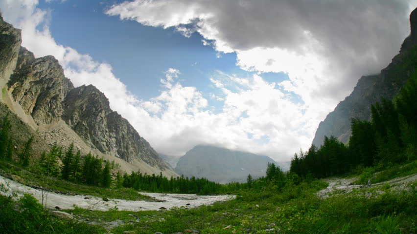 Timelapse landscape with white clouds and high mountain