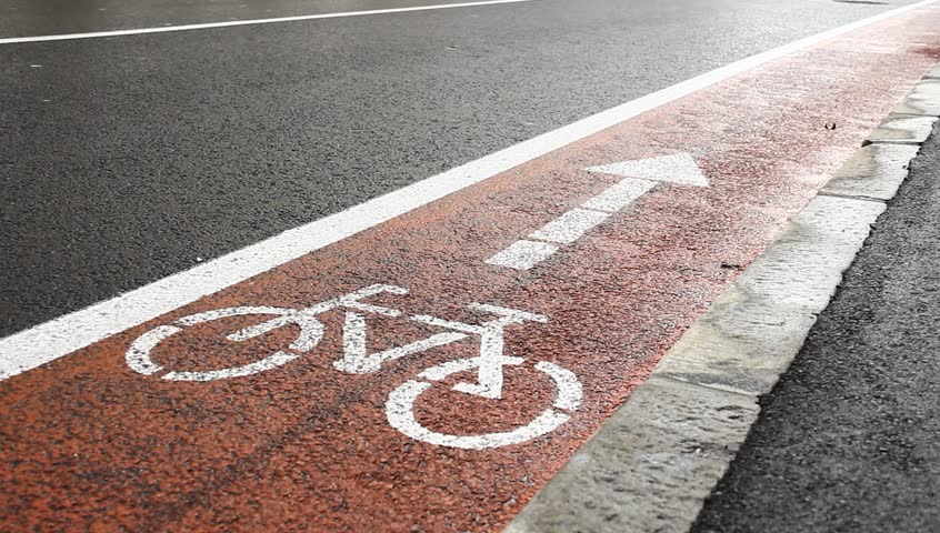 Red path with sign for bicyclists.