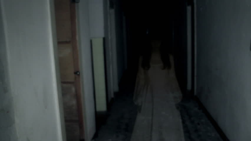 Female ghost in the dark hall