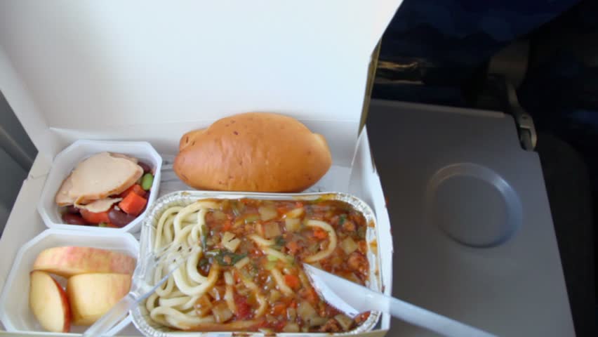 Meal for passenger in aircraft, closeup view in motion