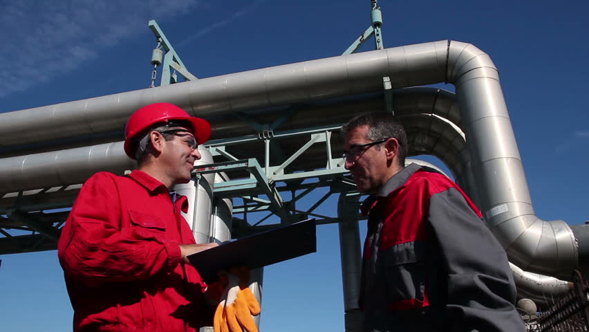 Industrial workers with clipboard working in power plant - Teamwork - 
Engineer signing a document in power plant. HD1080p.