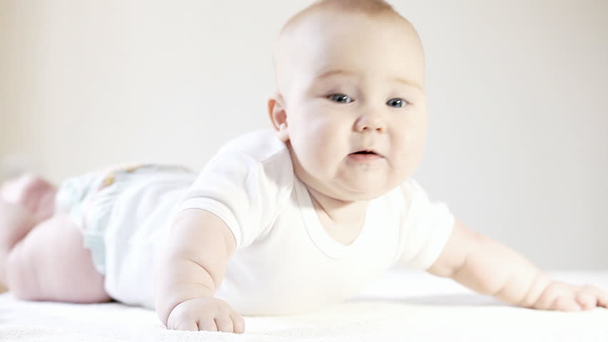 Smiling baby on the light background
