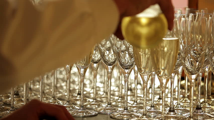 Waiter pours champagne into glasses