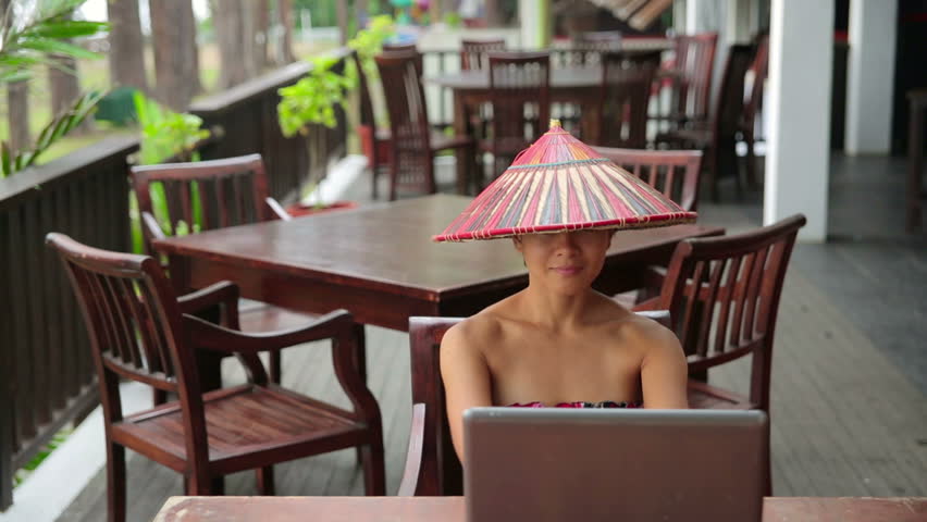 Asian freelance business woman at cafe with laptop and phone