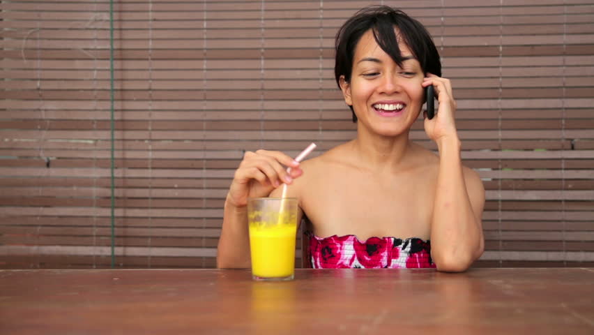 Freelance business woman working at cafe and chatting on cellular device