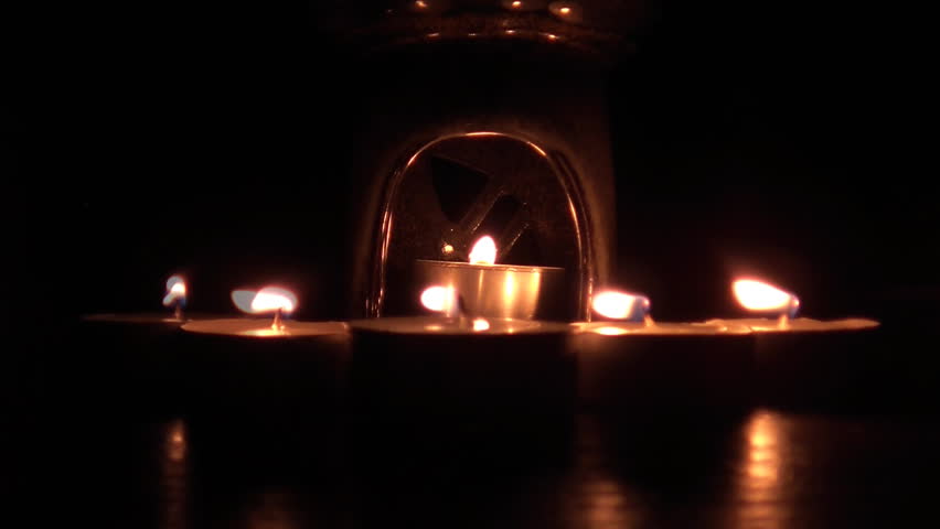 Beautiful candle lights in pitch black night 