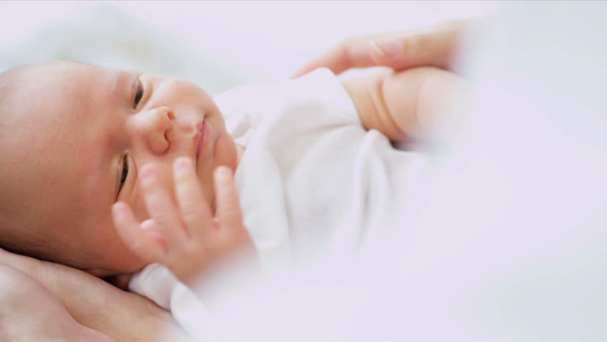 Close Up Parent holding Newborn baby