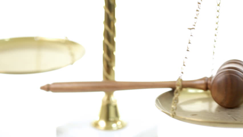 Pan of judges gavel on legal scales of justice.