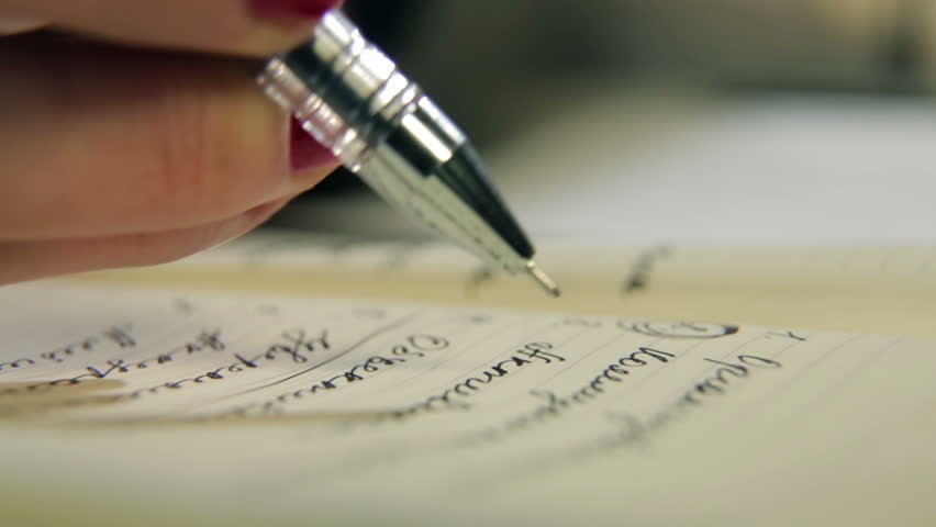 Woman writes a pen in daily