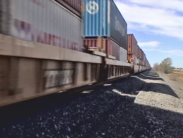 Video of a train passing by the camera in northern New Mexico desert. Shows the speed of the individual cars passing by. 