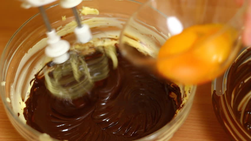 Making Chocolate Sponge Cake. Series. Pouring eggs into chocolate dough and mixing.