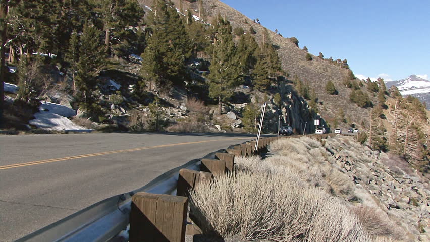 SIERRA NEVADA, CA - CIRCA 2012: Passenger cars and trucks file up and down the highway over Monitor Pass in the Sierra Nevada in spring time.