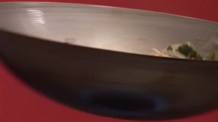 Tossing vegetables and sprouts in a wok