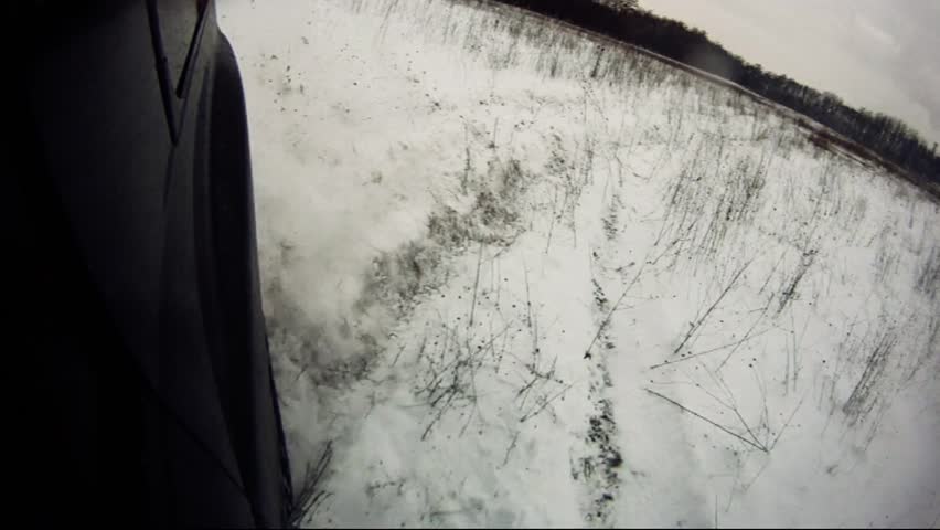 Driving through snowy, dirty lowland