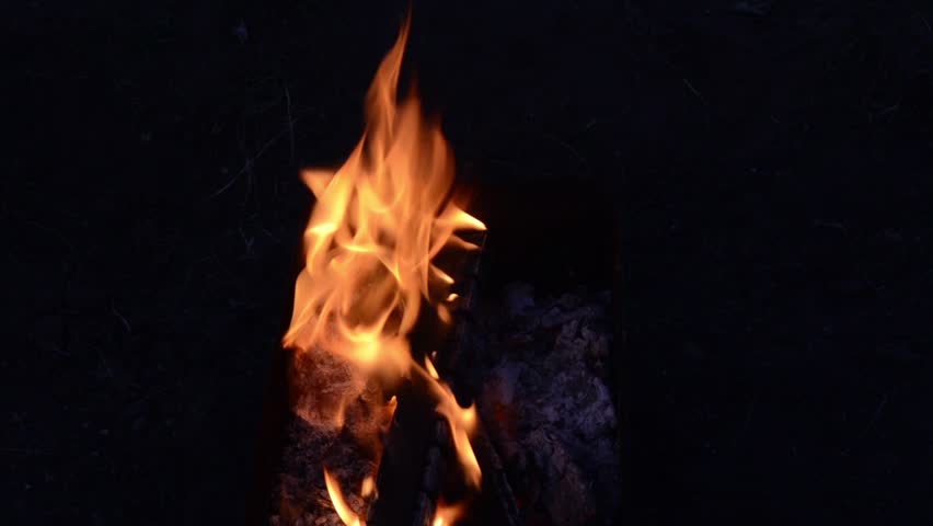 Fire burning in outdoor pit. 