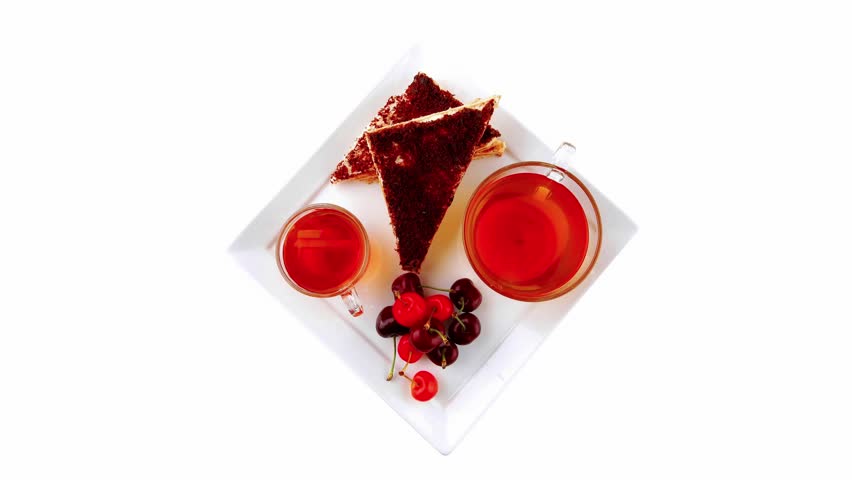english cake and tea with cherry on white plate