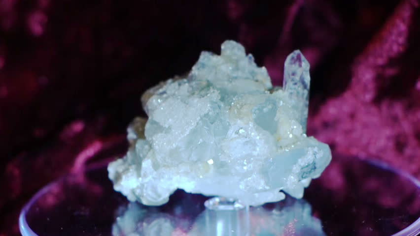 Beautiful aquamarine crystal rotating on a demonstration stand