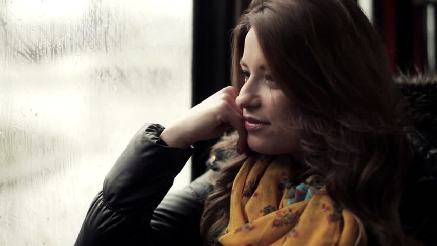 Pensive young woman riding the tram, steadicam shot
