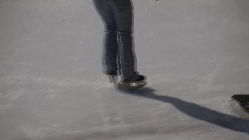 Closeup shot of an ice skater's feet on an ice rink (High Definition)