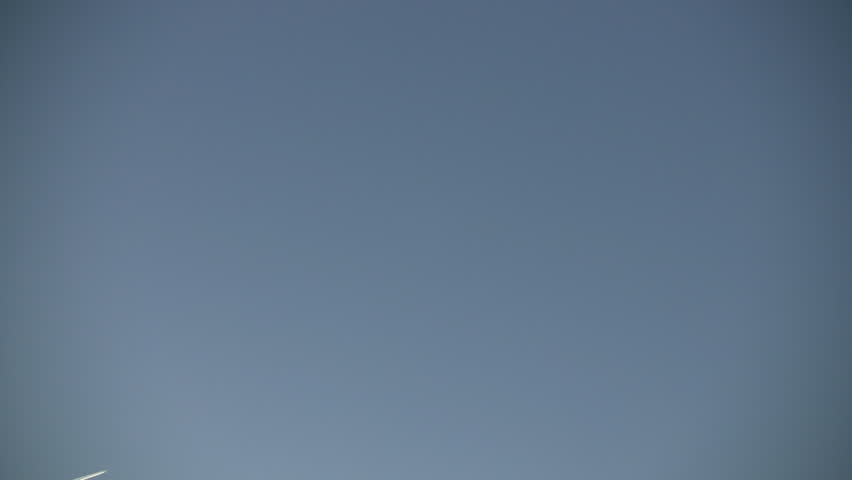 Condensation vapour trails are left behind from a passing airplane.  Also known as contrails, cirrus clouds, or wingtip vortices (High Definition)