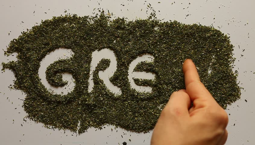 Young adult woman writes GREEN word in dry dill.
