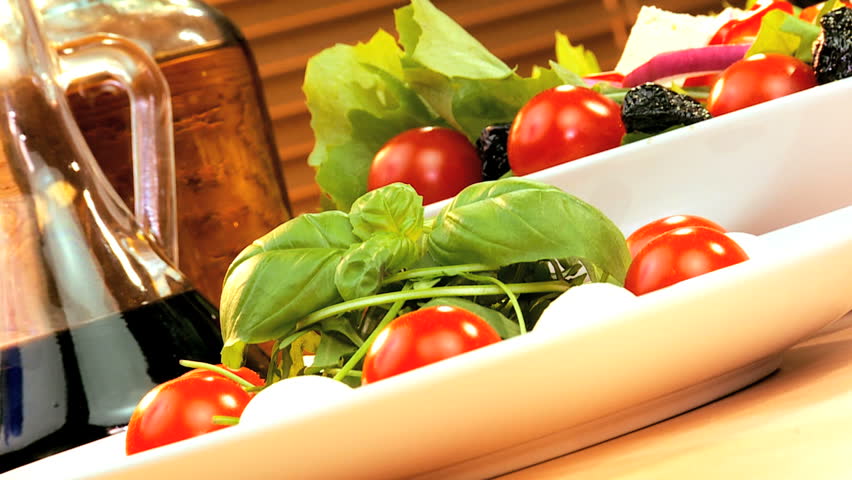 Tempting selection of fresh salad, cheese & oils making a healthy nutritious meal