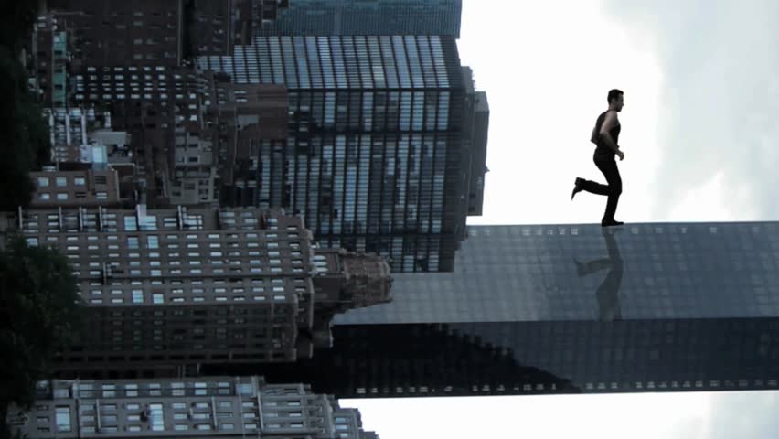 man climbs skyscraper. city superhero. surreal running man powerful illusion.