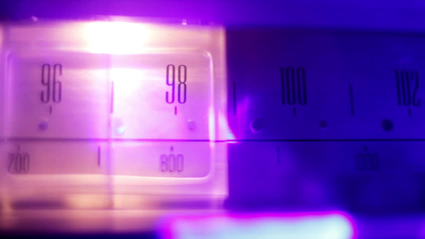 a glowing radio with the marker running through the different stations and frequencies
